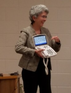 Dr. Aguilar shows an auditory device to attendees.